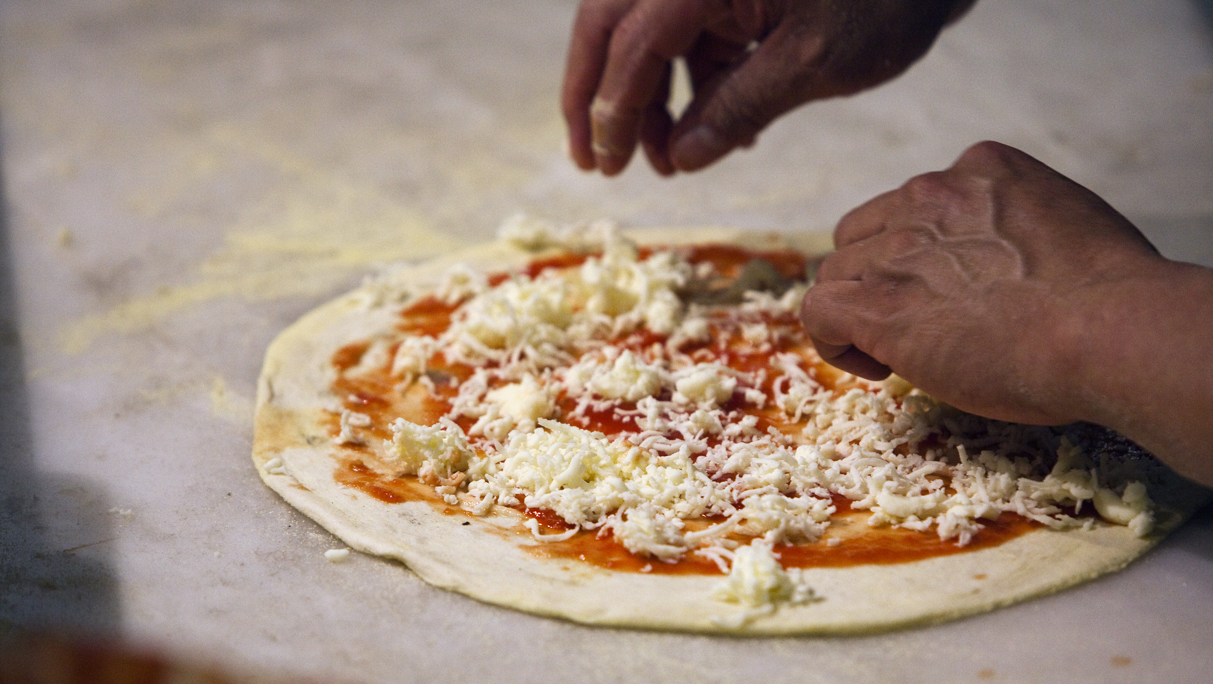 Pizza with greens, cranberries and blue cheese, fresh from the oven