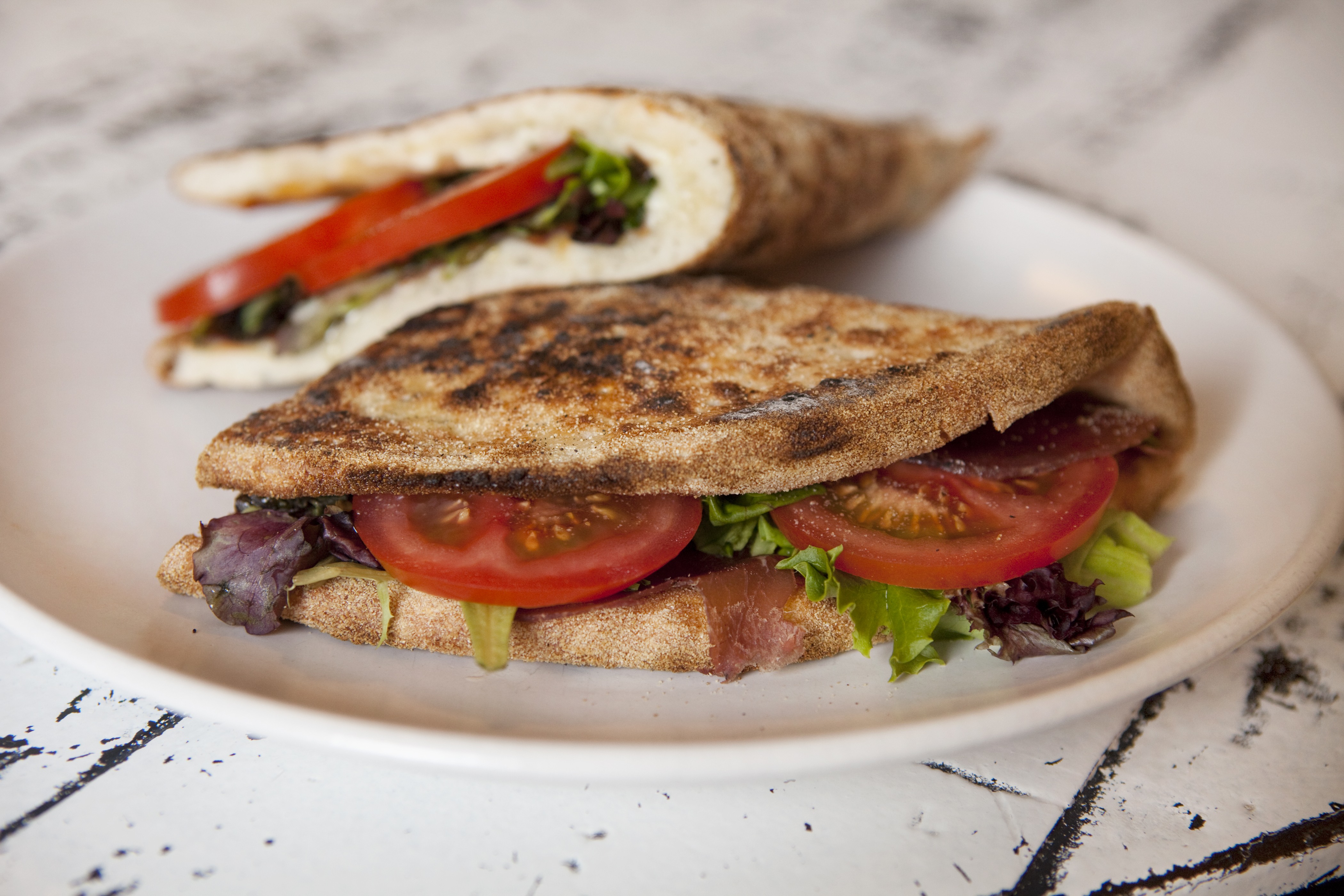 Grilled piadina with prosciutto, tomato and greens at Hot Italian