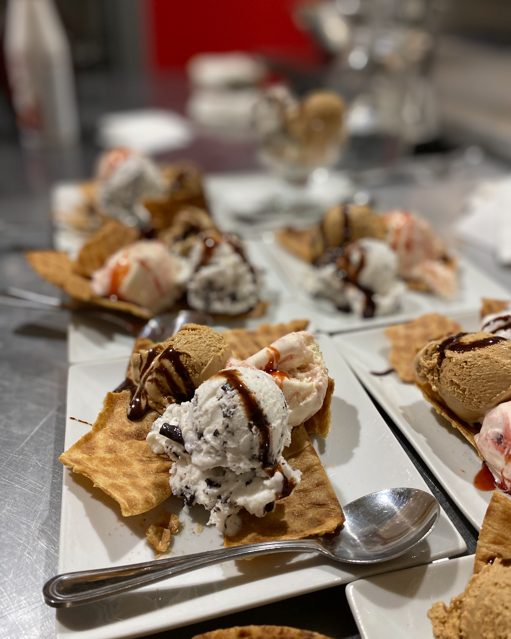 Scoops of gelato on wafer with chocolate sauce